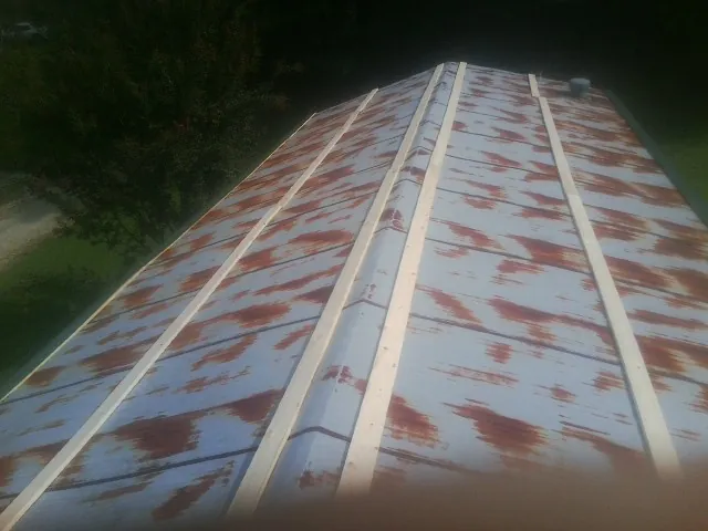 Rusted metal roof panels with new wood purlins before replacement — Storm Damage Roof Repair in Schoharie by Roofing Brothers