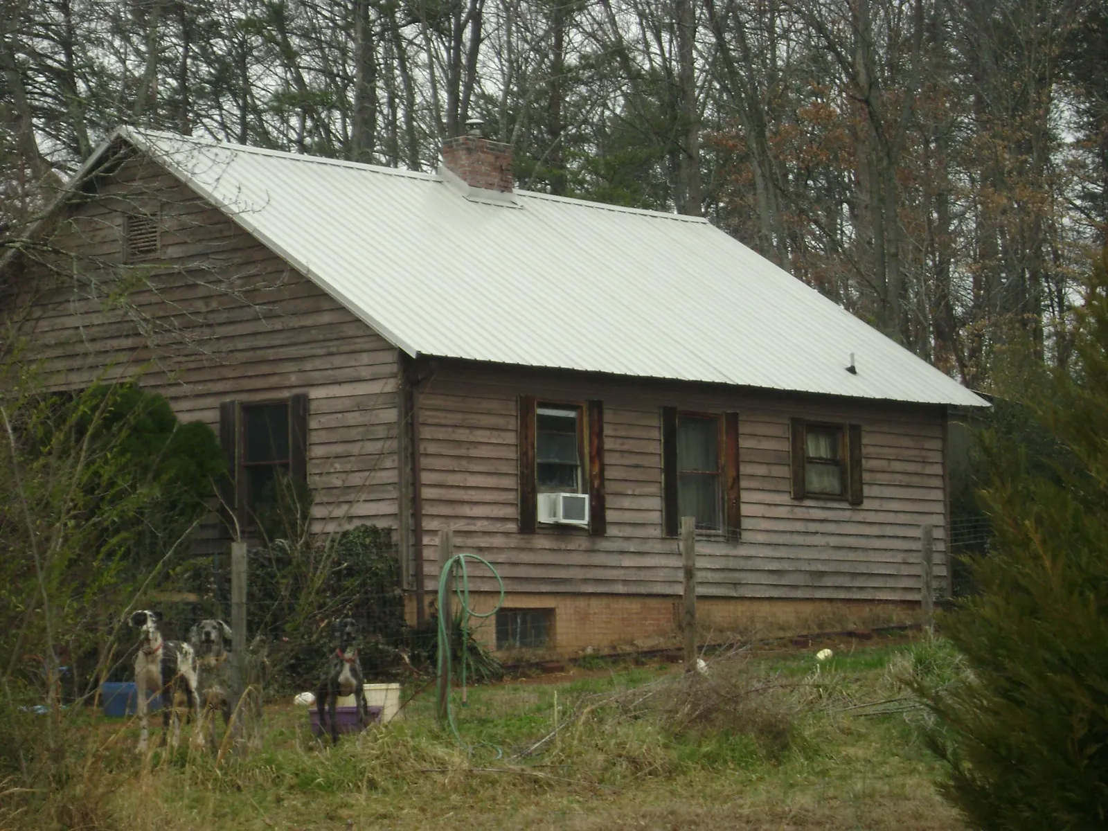 White metal roof on an old wood sided farmhouse, from a Metal Roof Installation job in Schoharie